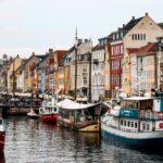 Vibrant buildings and boats line the scenic Nyhavn Canal in Copenhagen, Denmark.